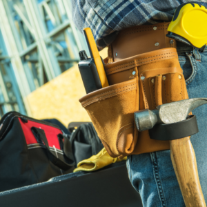 preferred professionals - Construction worker with tool belt working on a house