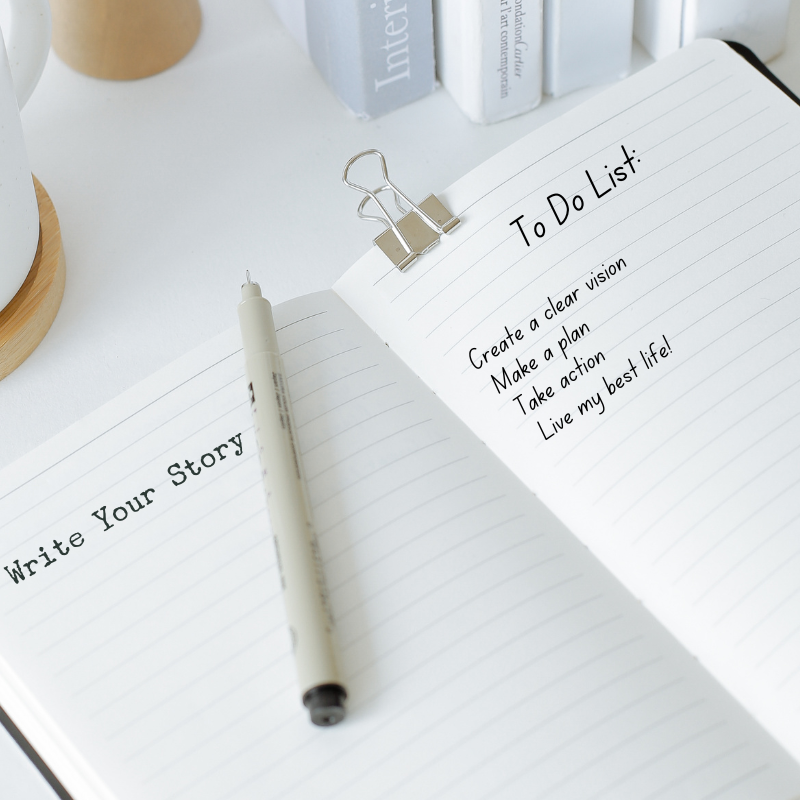 open notebook with a pen and list of action steps to write your own story